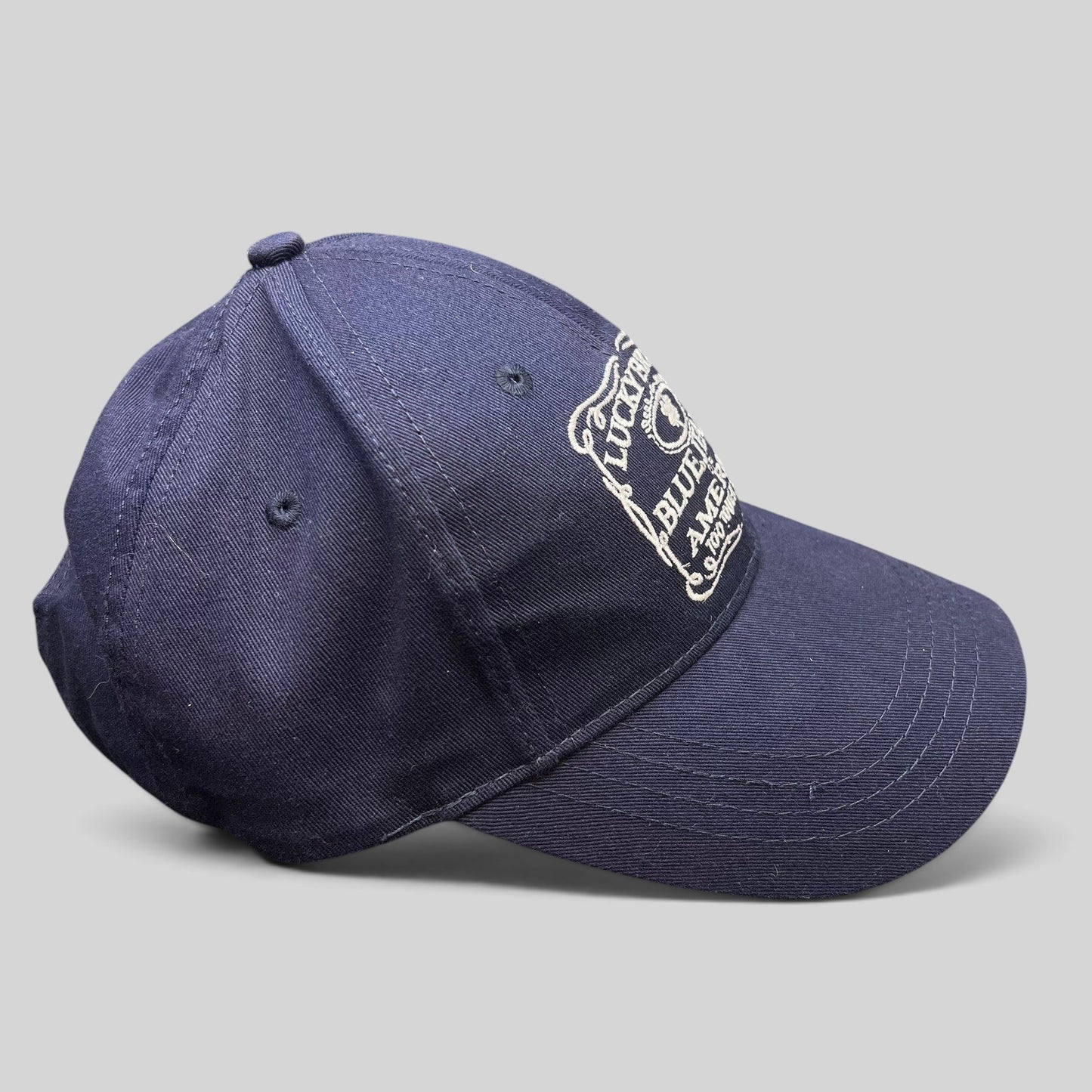 Raree Finds navy cotton twill snapback hat featuring white Lucky Brand Blue Jeans of America embroidered logo