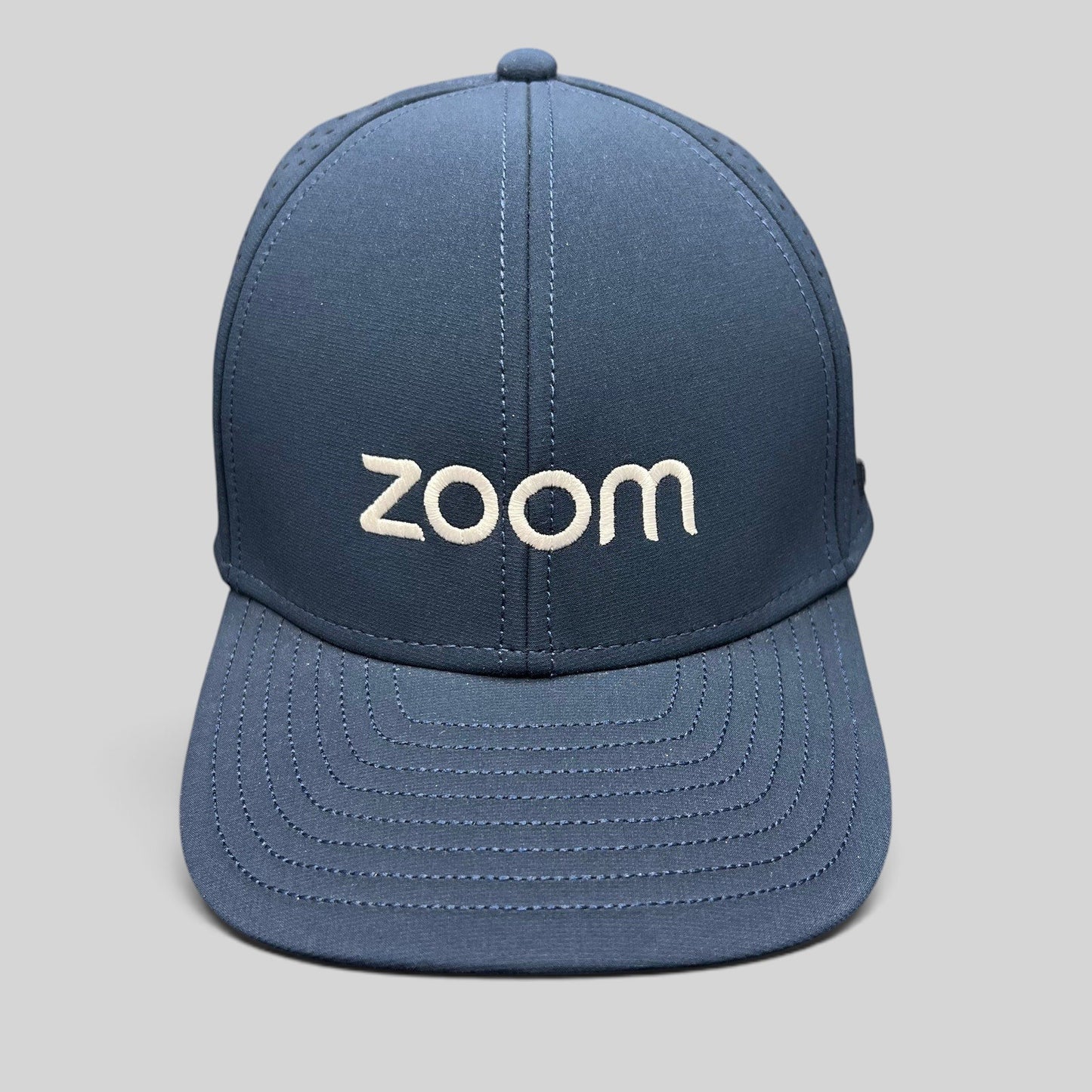 Raree Finds navy Melin Hydro A-Game snapback hat with white Zoom embroidery and laser-perforated performance fabric.