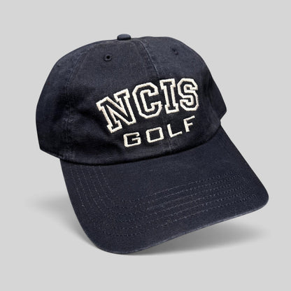 Raree Finds vintage navy blue NCIS Golf tournament strapback hat with white embroidered lettering on the crown.