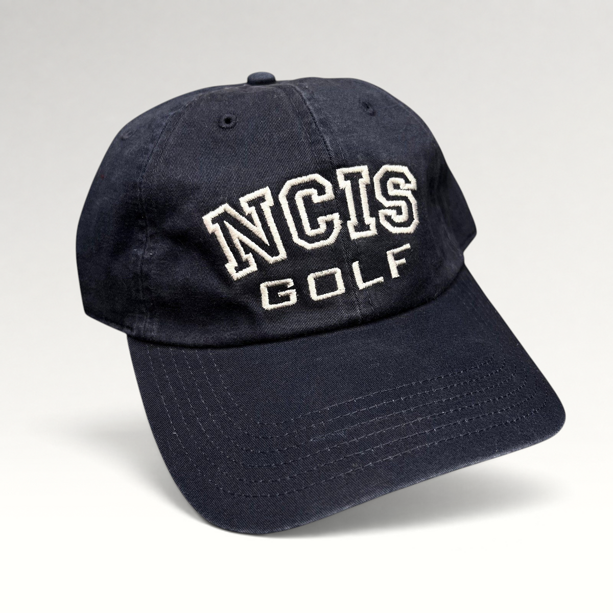 Raree Finds vintage navy blue NCIS Golf tournament strapback hat with white embroidered lettering on the crown.