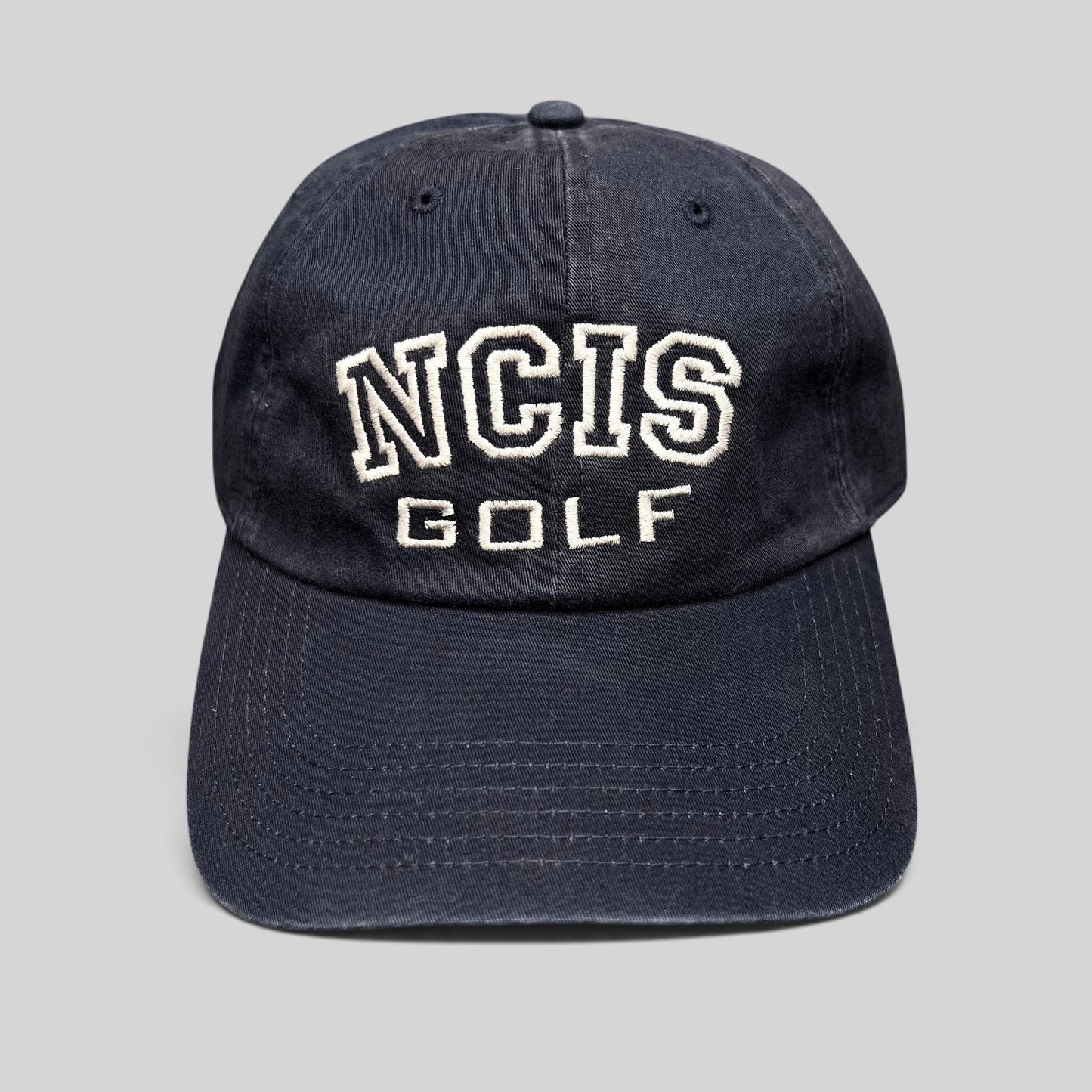 Raree Finds vintage navy blue NCIS Golf tournament strapback hat with white embroidered lettering on the crown.