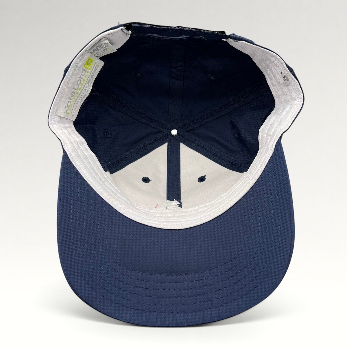 Raree Finds navy performance fabric cap interior view showing structured crown and Kate Lord branding label