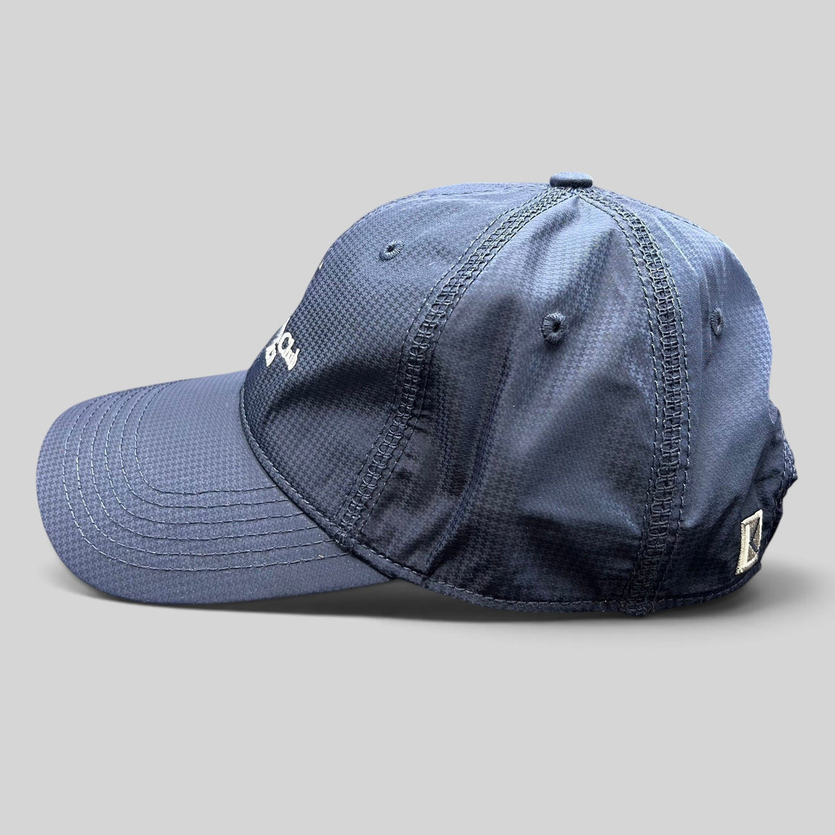 Raree Finds navy performance fabric cap with white embroidered logo and curved brim, side profile view.