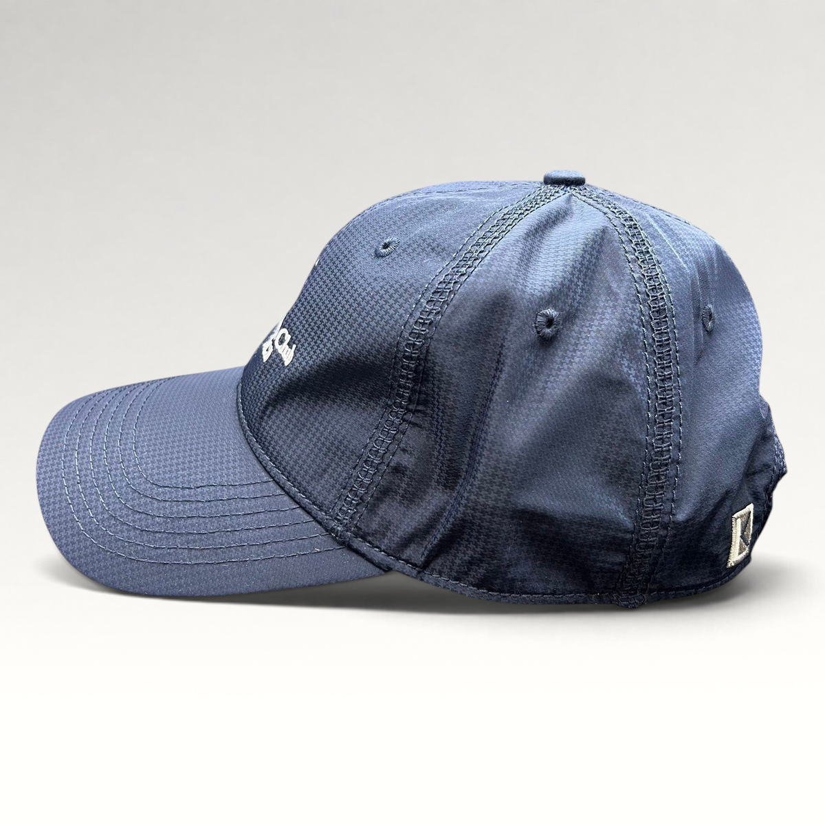 Raree Finds navy performance fabric cap with white embroidered logo and curved brim, side profile view.