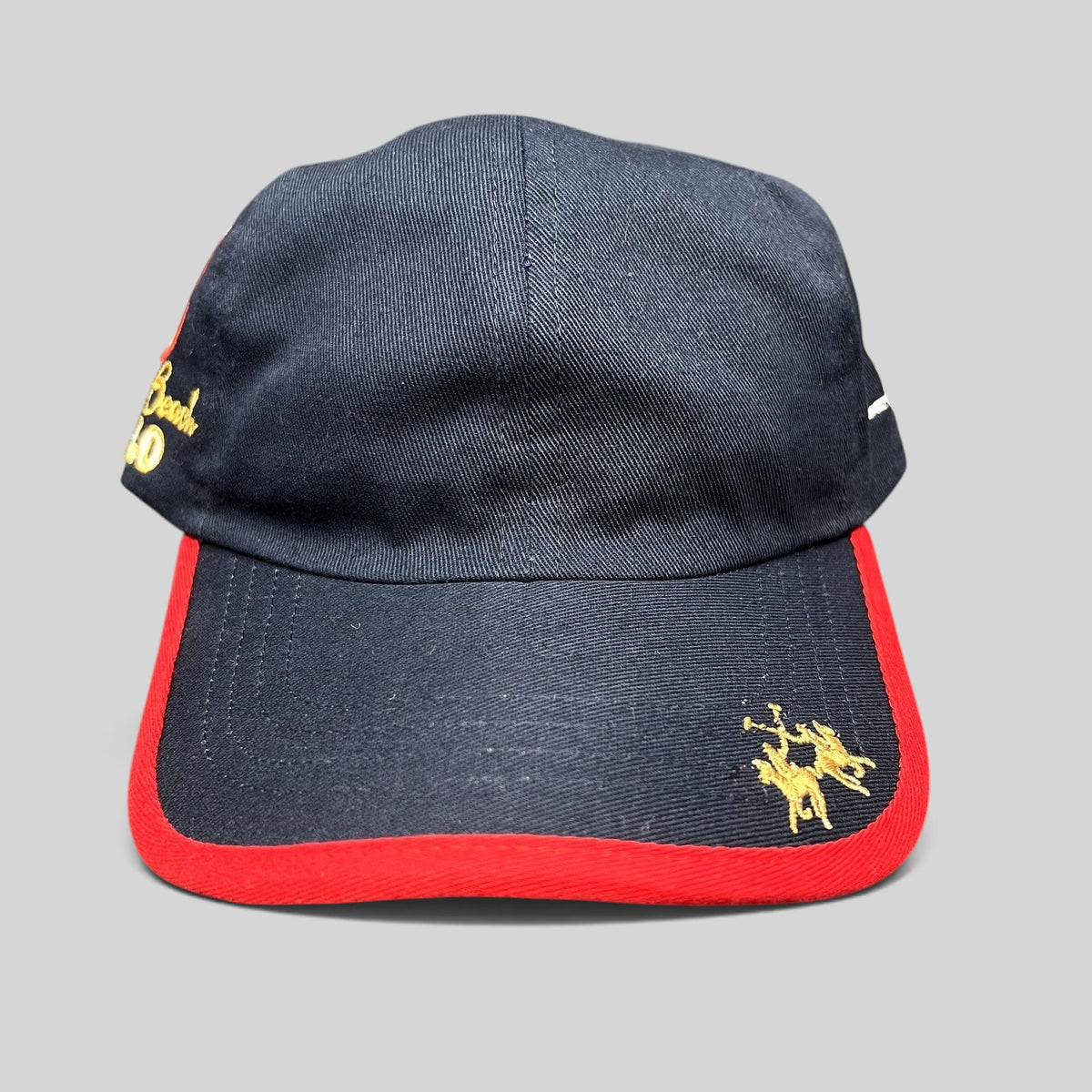 Raree Finds vintage navy blue cotton strapback hat with red brim piping, gold polo rider logo, and Miami Beach script.