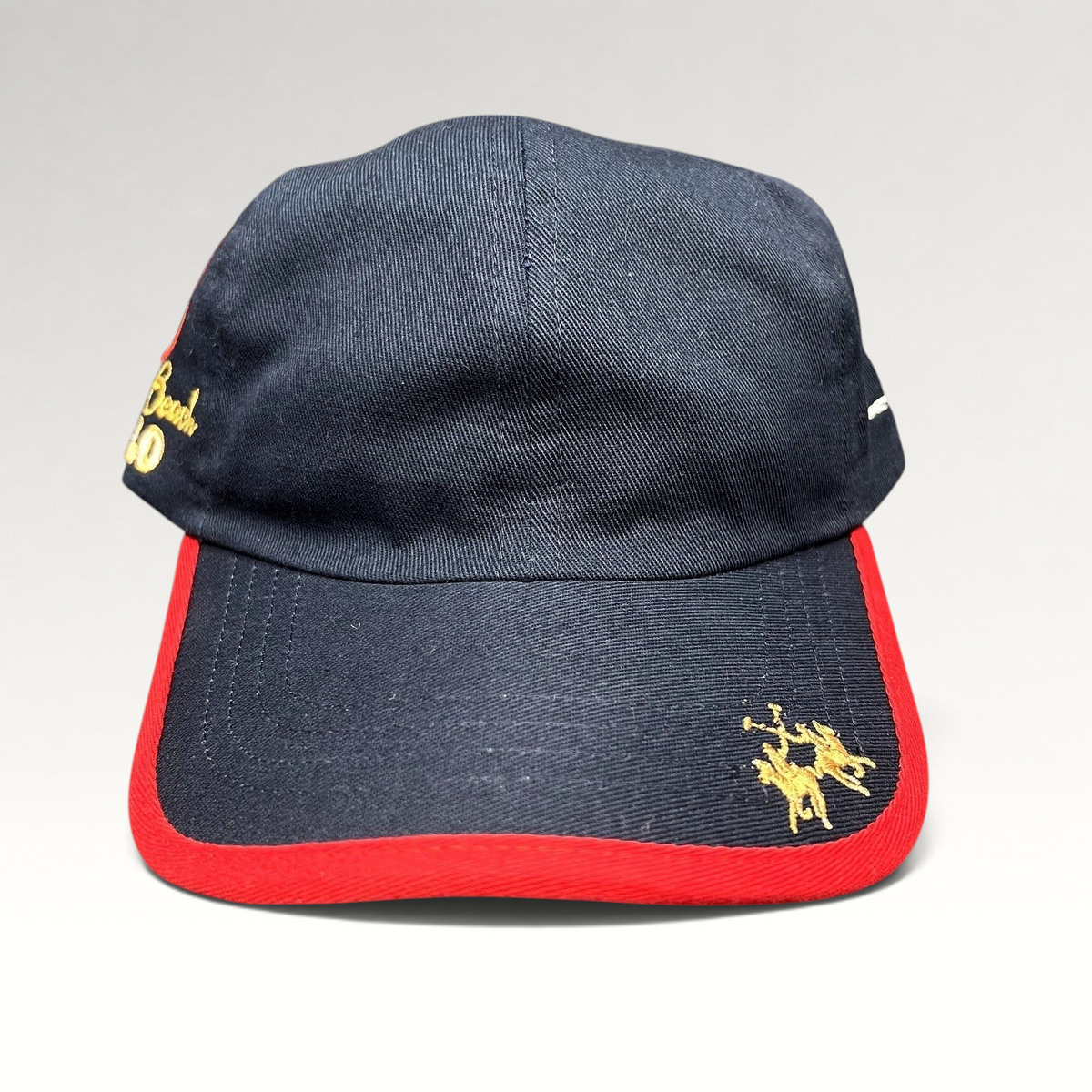 Raree Finds vintage navy blue cotton strapback hat with red brim piping, gold polo rider logo, and Miami Beach script.