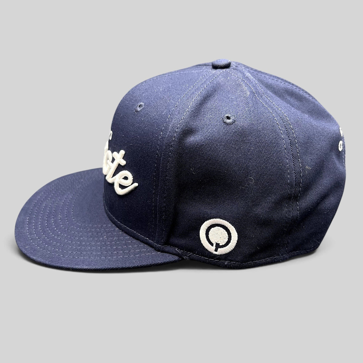 Raree Finds navy blue Quixote Studios snapback hat with white raised embroidery and flat brim
