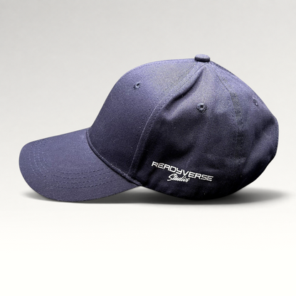 Raree Finds navy blue Readyverse Studios strapback dad cap with white side embroidery on a grey background