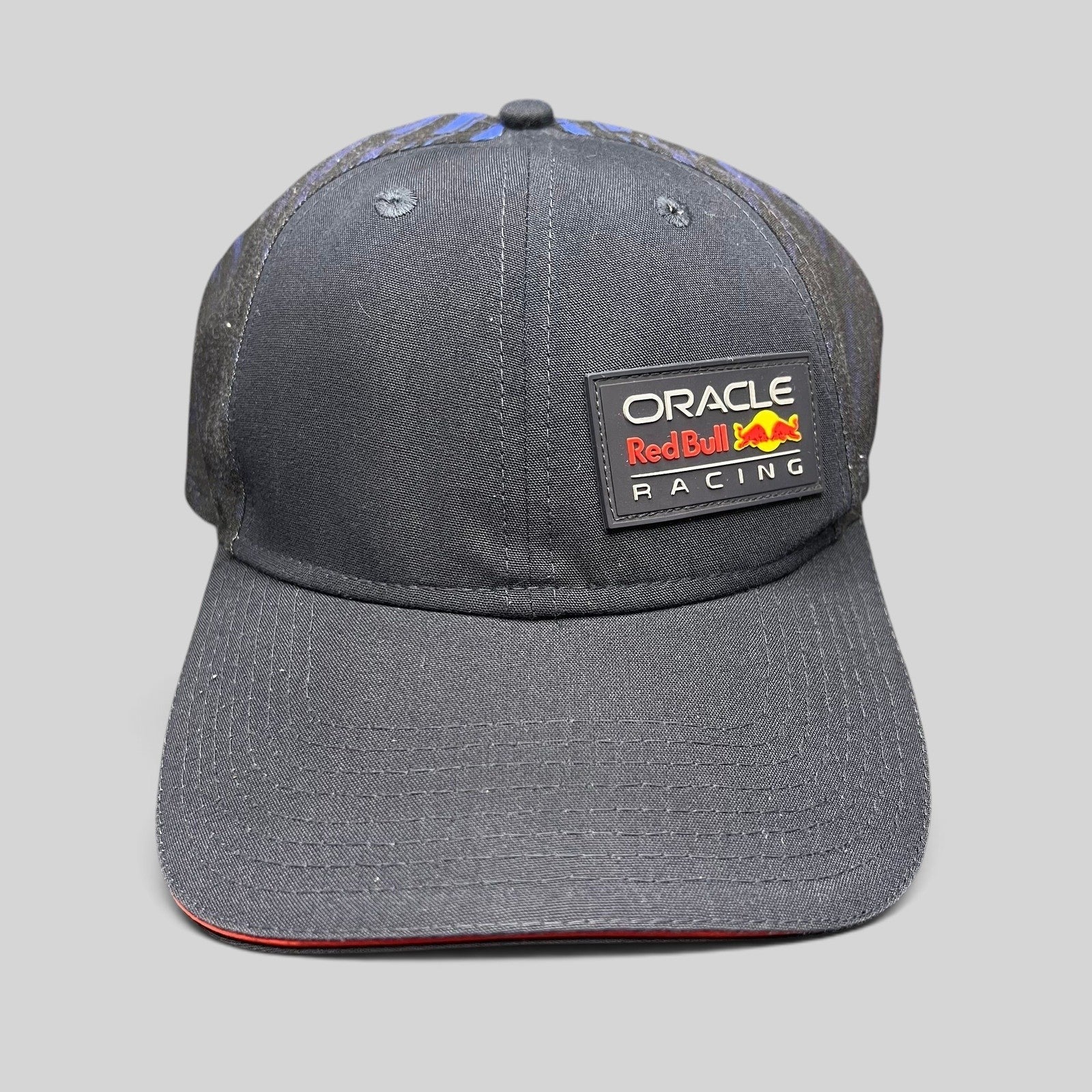 Raree Finds navy Oracle Red Bull Racing New Era 9FORTY snapback cap with a rubberized front logo and red brim trim.