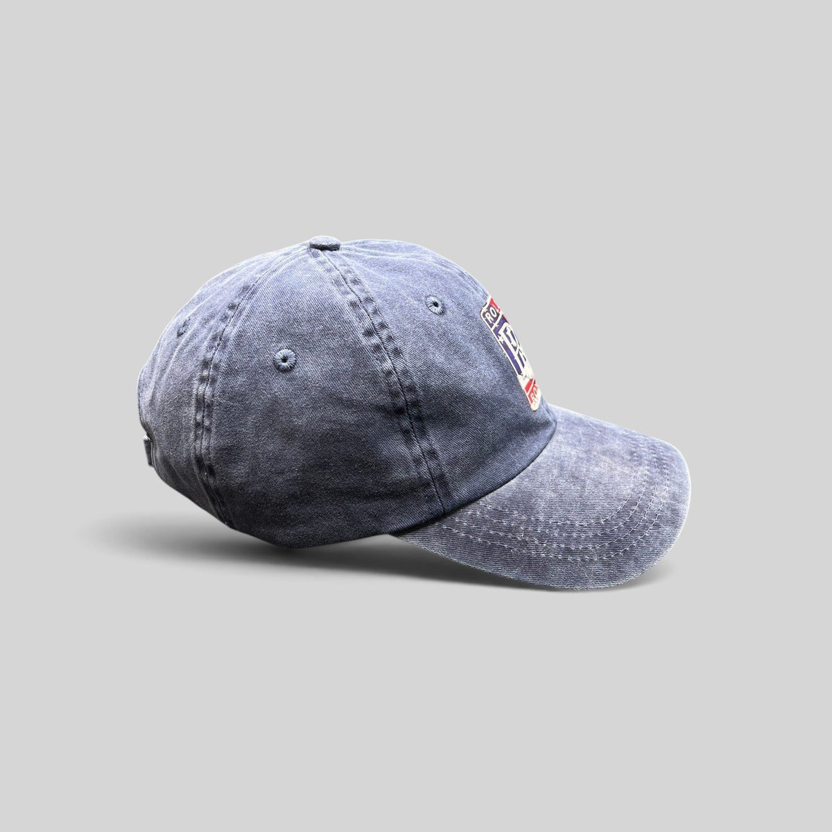 Raree Finds navy washed cotton dad hat with a patriotic Rolls-Royce crest patch and adjustable strap closure.