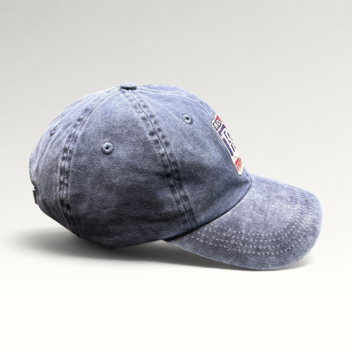 Raree Finds navy washed cotton dad hat with a patriotic Rolls-Royce crest patch and adjustable strap closure.