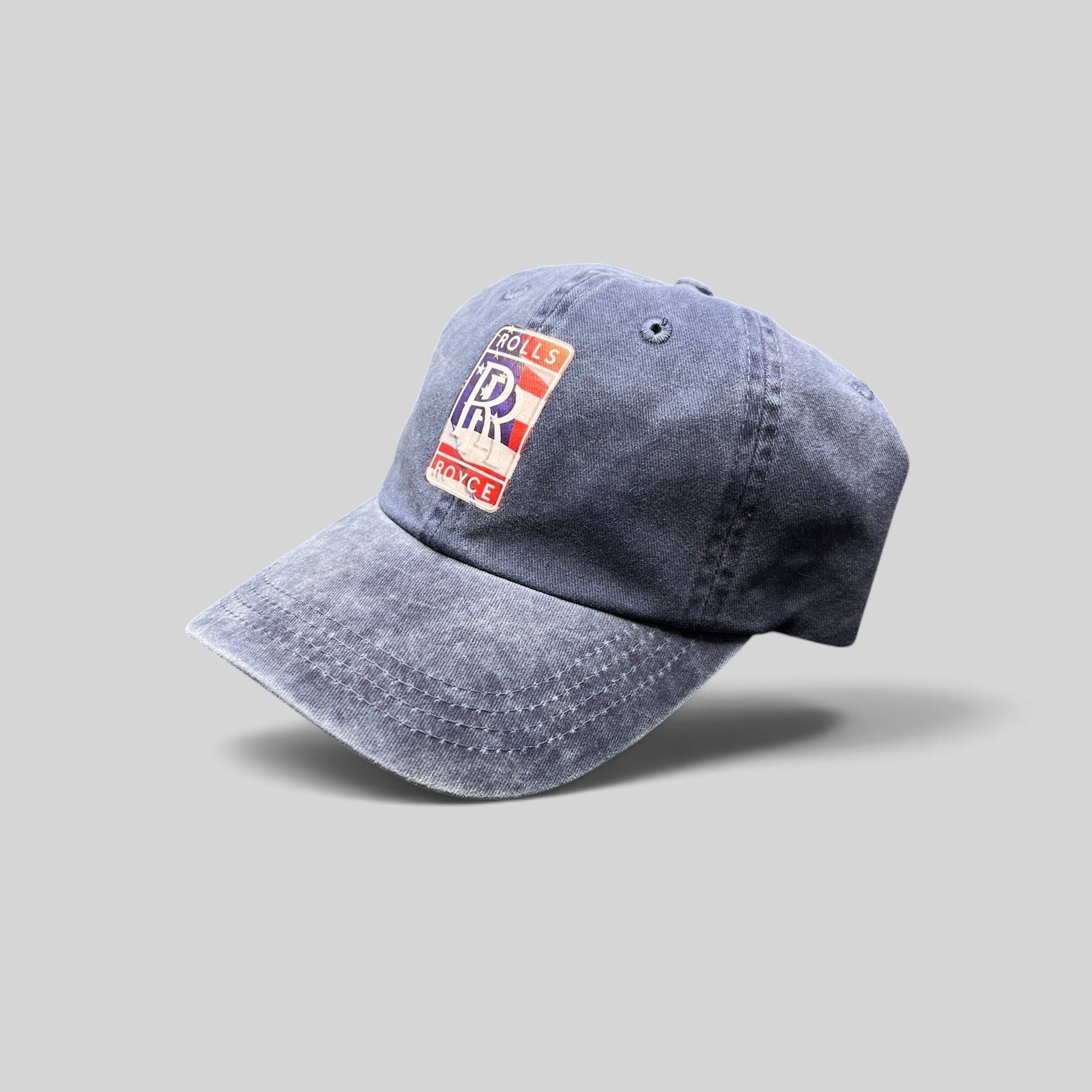 Raree Finds navy dad hat with a vintage-washed cotton finish and a patriotic Rolls-Royce USA crest patch.