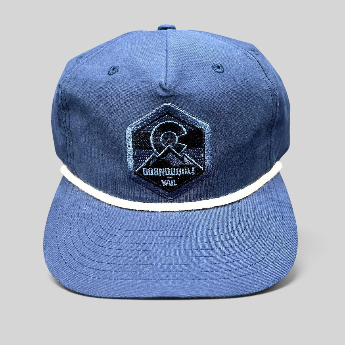 Raree Finds navy blue Boondoggle Vail snapback hat with white rope detail and Colorado mountain logo patch