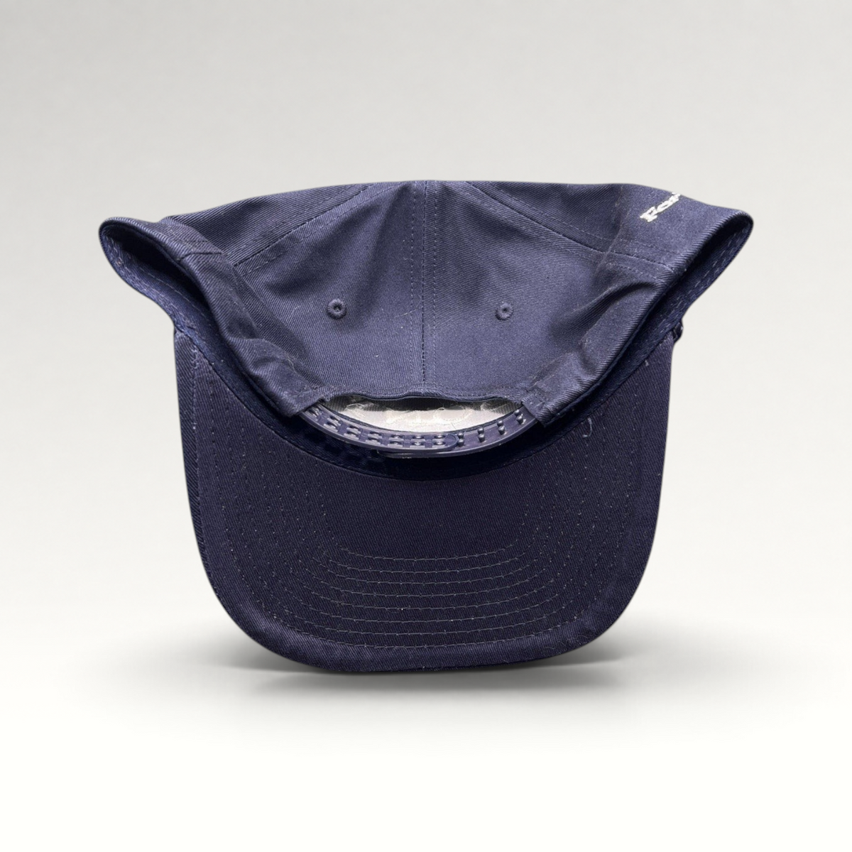Raree Finds navy blue snapback hat with rope brim and adjustable plastic closure, viewed from the back.