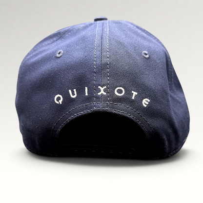 Raree Finds navy blue snapback hat featuring white Quixote embroidery on the back of the structured crown