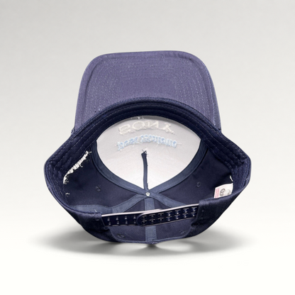Raree Finds navy blue snapback hat with interior view showing structured foam front and adjustable plastic closure