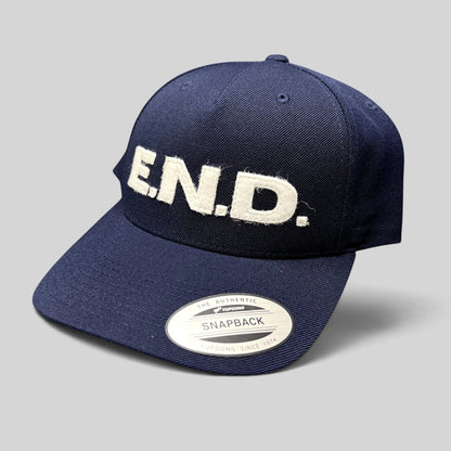 Raree Finds navy blue Yupoong Classics snapback hat with white felt E.N.D. lettering on the front crown.