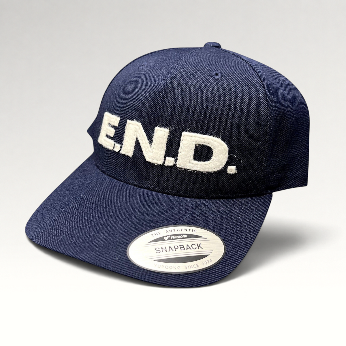 Raree Finds navy blue Yupoong Classics snapback hat with white felt E.N.D. lettering on the front crown.