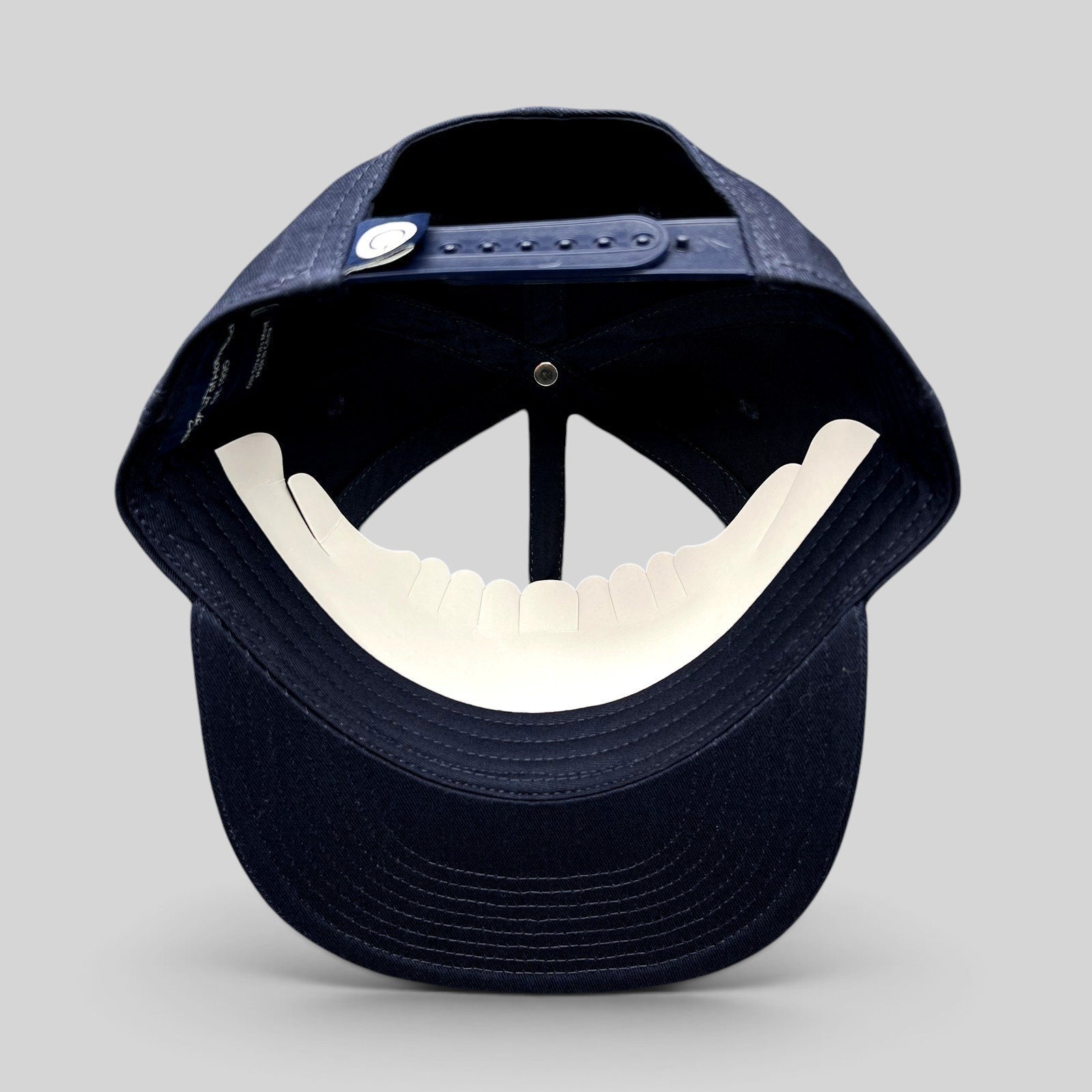 Raree Finds navy blue Quixote Studios snapback hat with adjustable plastic snap closure and flat brim