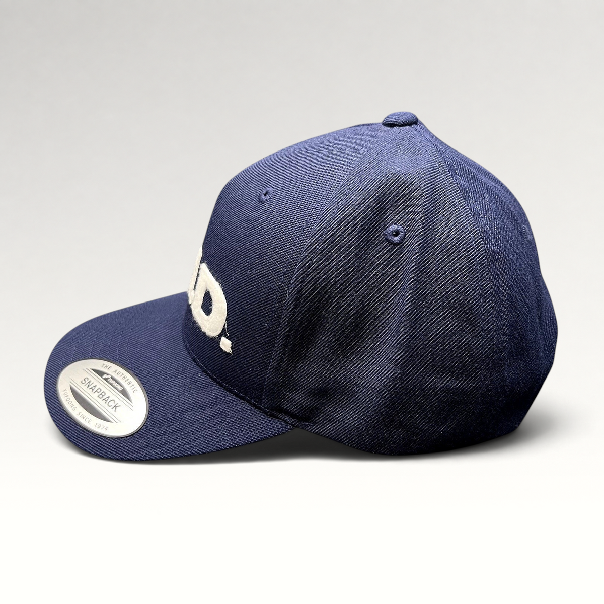 Raree Finds navy blue Yupoong Classics snapback hat with white felt E.N.D. lettering on the structured crown.