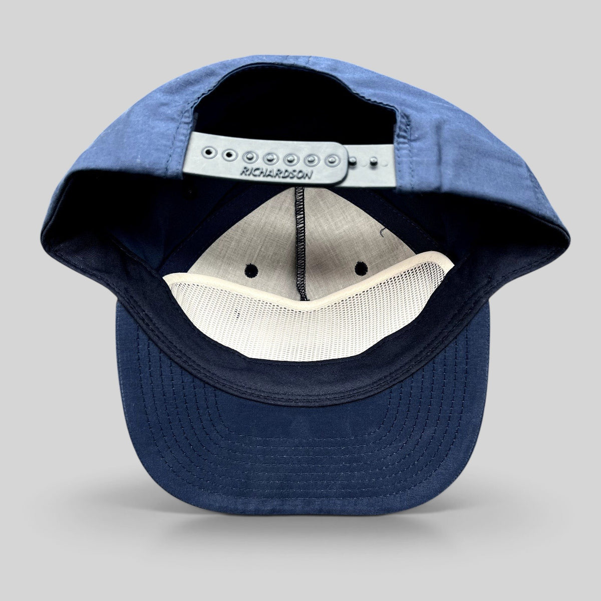 Raree Finds navy blue Richardson Outdoor snapback hat showing the interior mesh lining and adjustable plastic strap