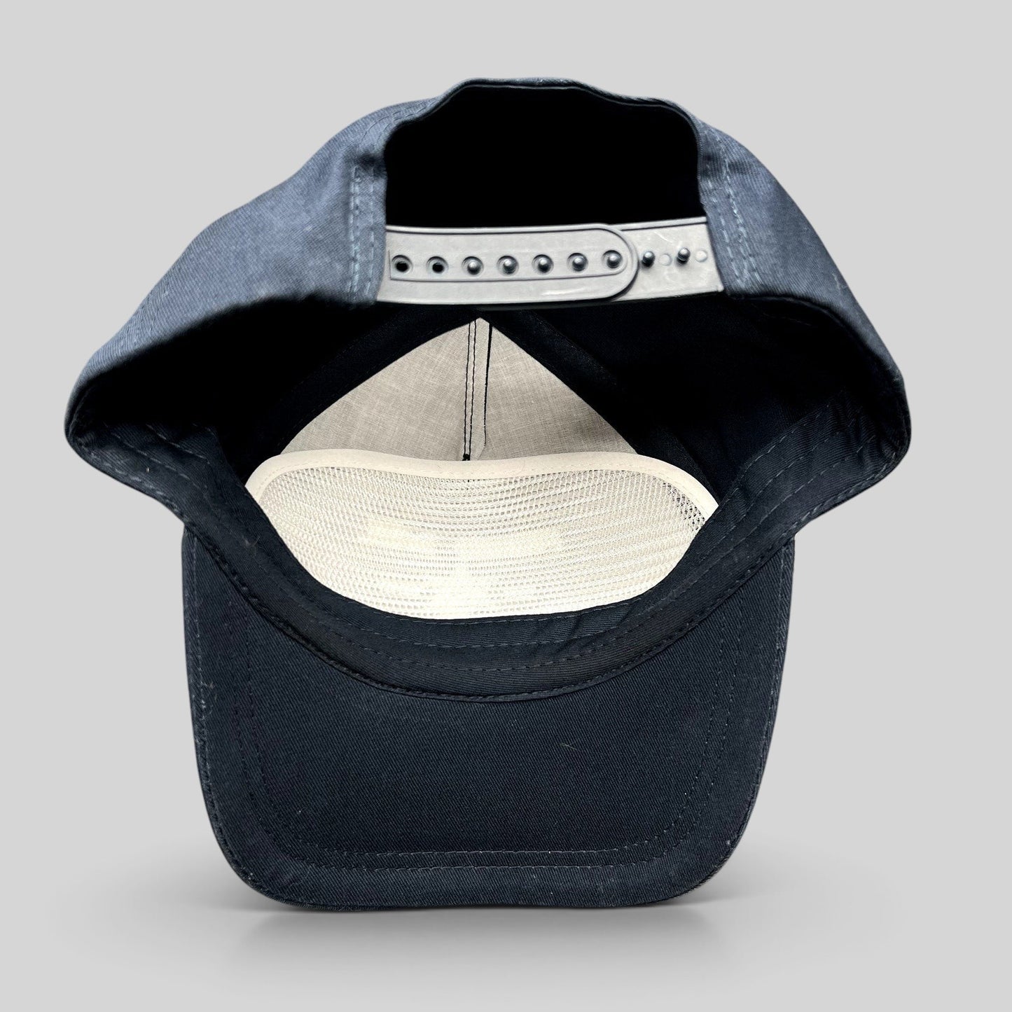 Raree Finds navy blue snapback hat interior view showing adjustable strap and white mesh lining