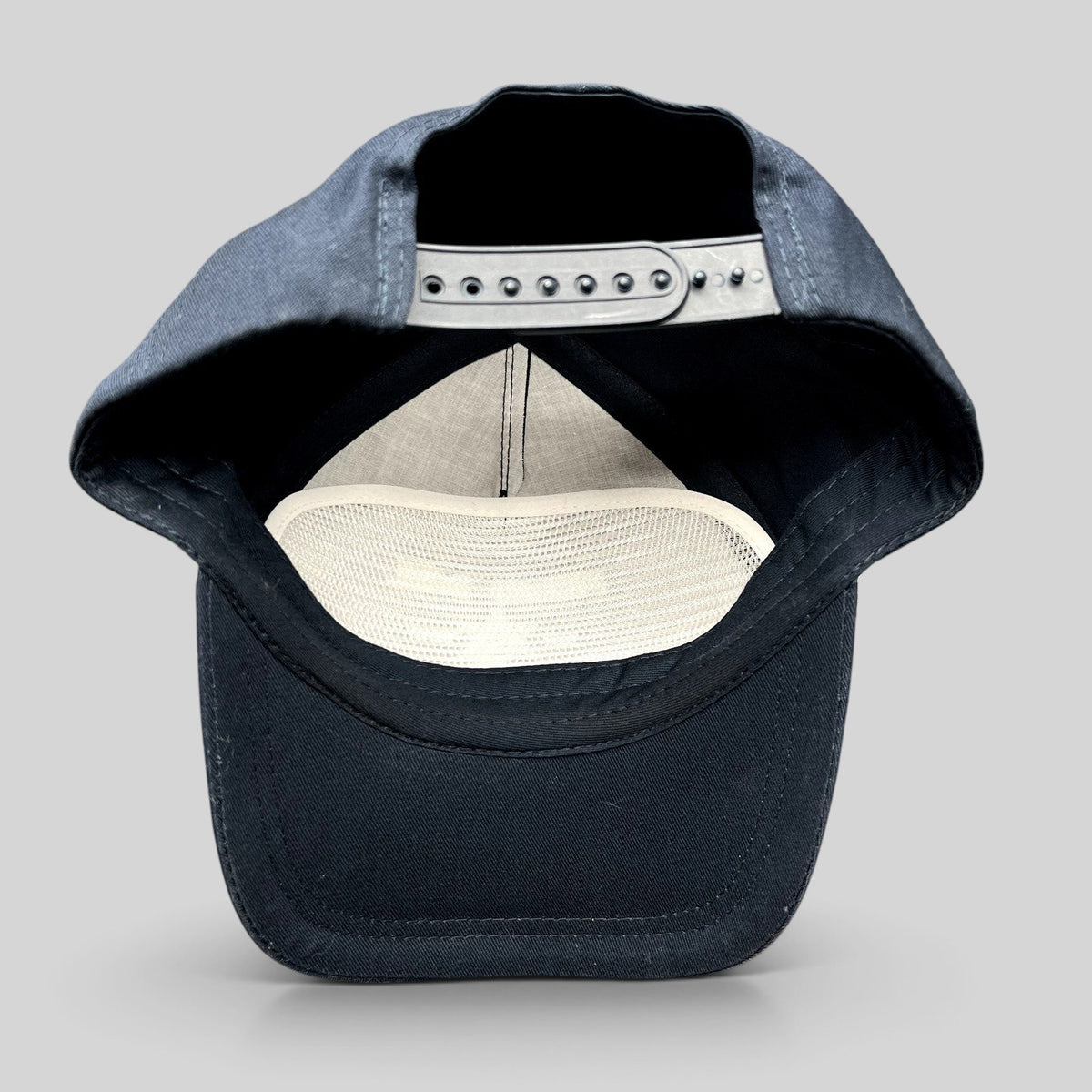 Raree Finds navy blue snapback hat interior view showing adjustable strap and white mesh lining