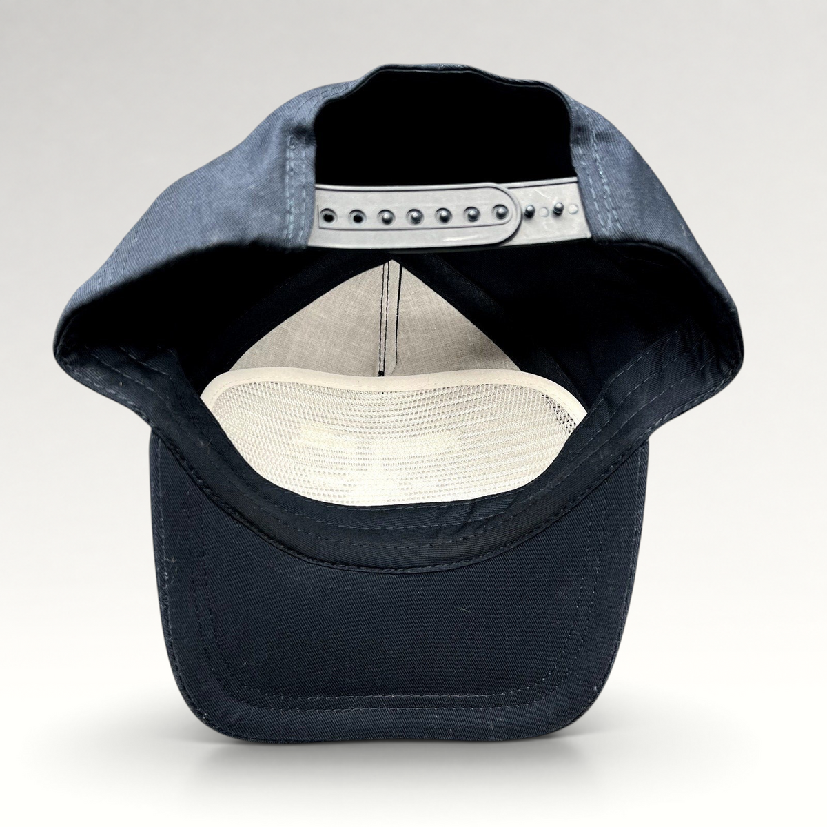 Raree Finds navy blue snapback hat interior view showing adjustable strap and white mesh lining