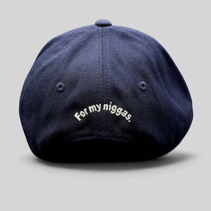 Raree Finds navy blue Yupoong Classics snapback hat with white embroidered slogan on the back