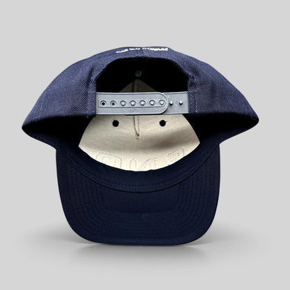 Raree Finds navy blue Yupoong Classics snapback hat showing the adjustable plastic strap and rear embroidery detail.