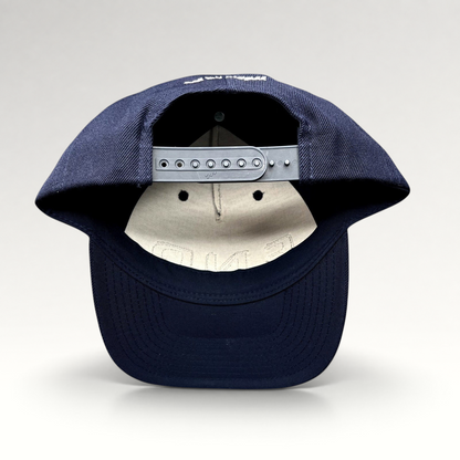 Raree Finds navy blue Yupoong Classics snapback hat showing the adjustable plastic strap and rear embroidery detail.