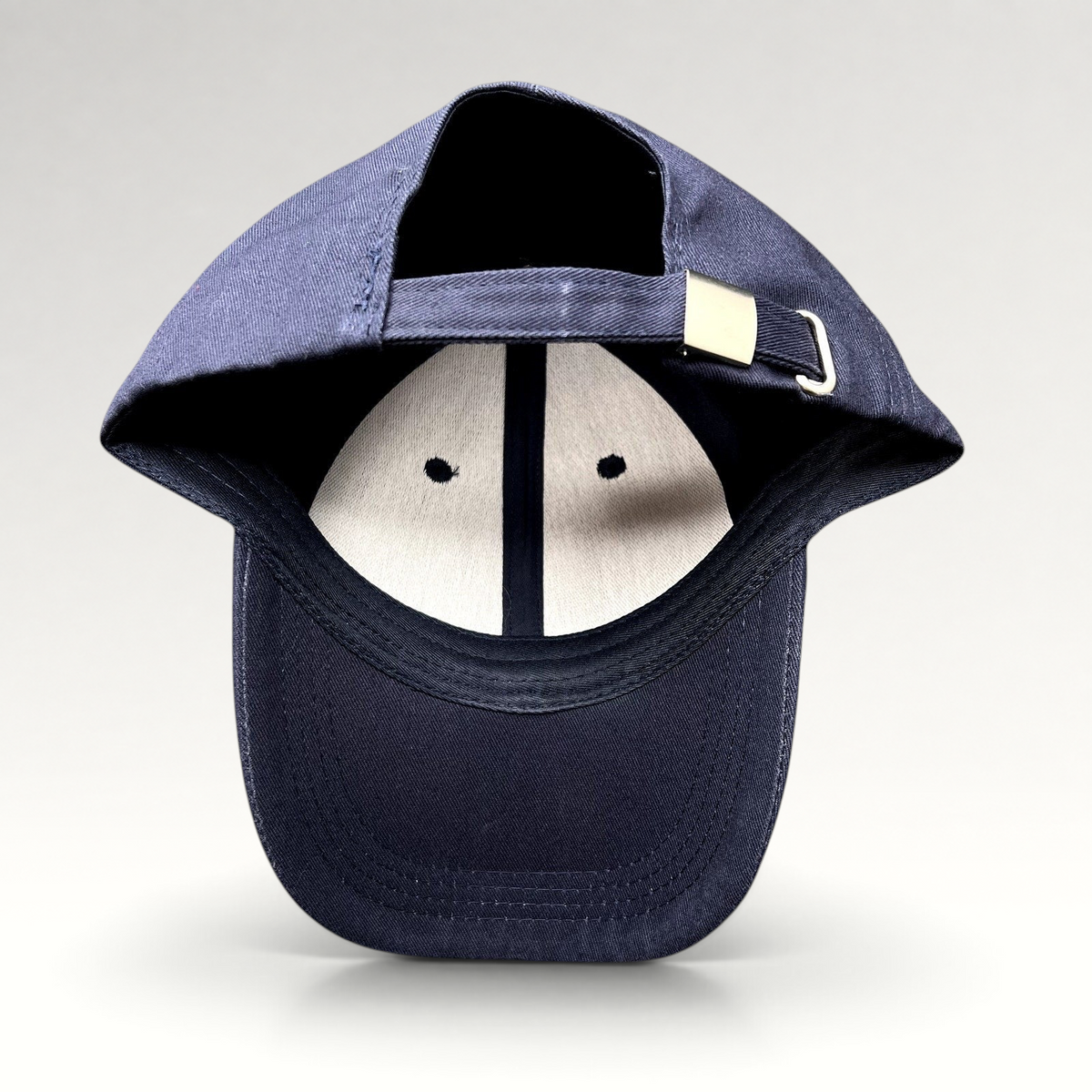 Raree Finds navy blue Readyverse Studios strapback dad cap showing the adjustable metal buckle and interior lining