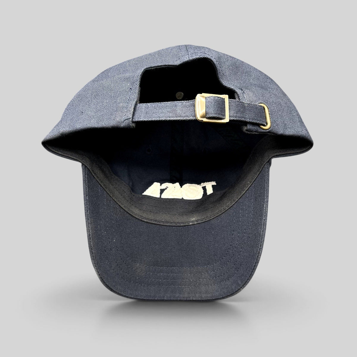 Raree Finds navy blue cotton dad cap with adjustable strapback closure and brass buckle, rear view