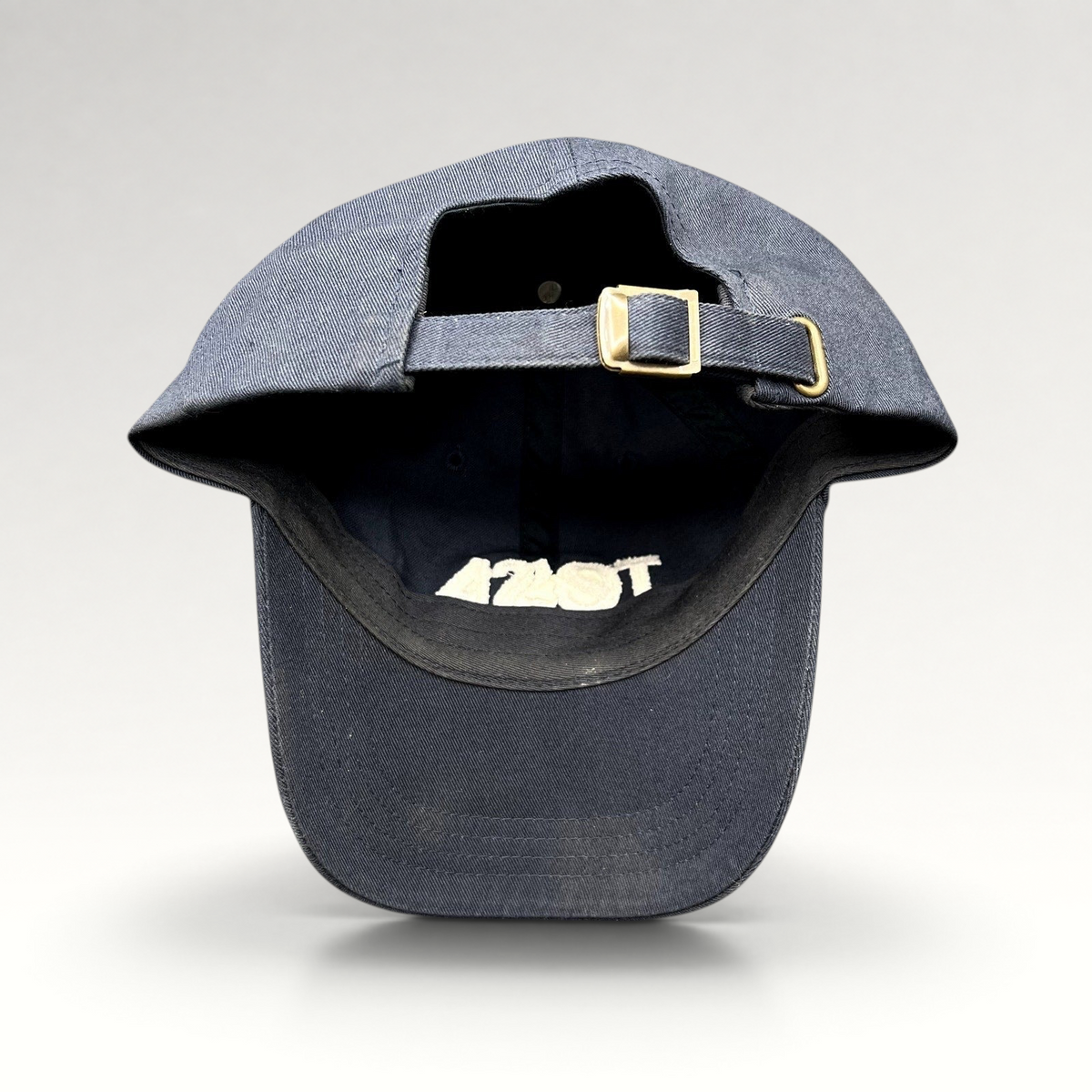 Raree Finds navy blue cotton dad cap with adjustable strapback closure and brass buckle, rear view