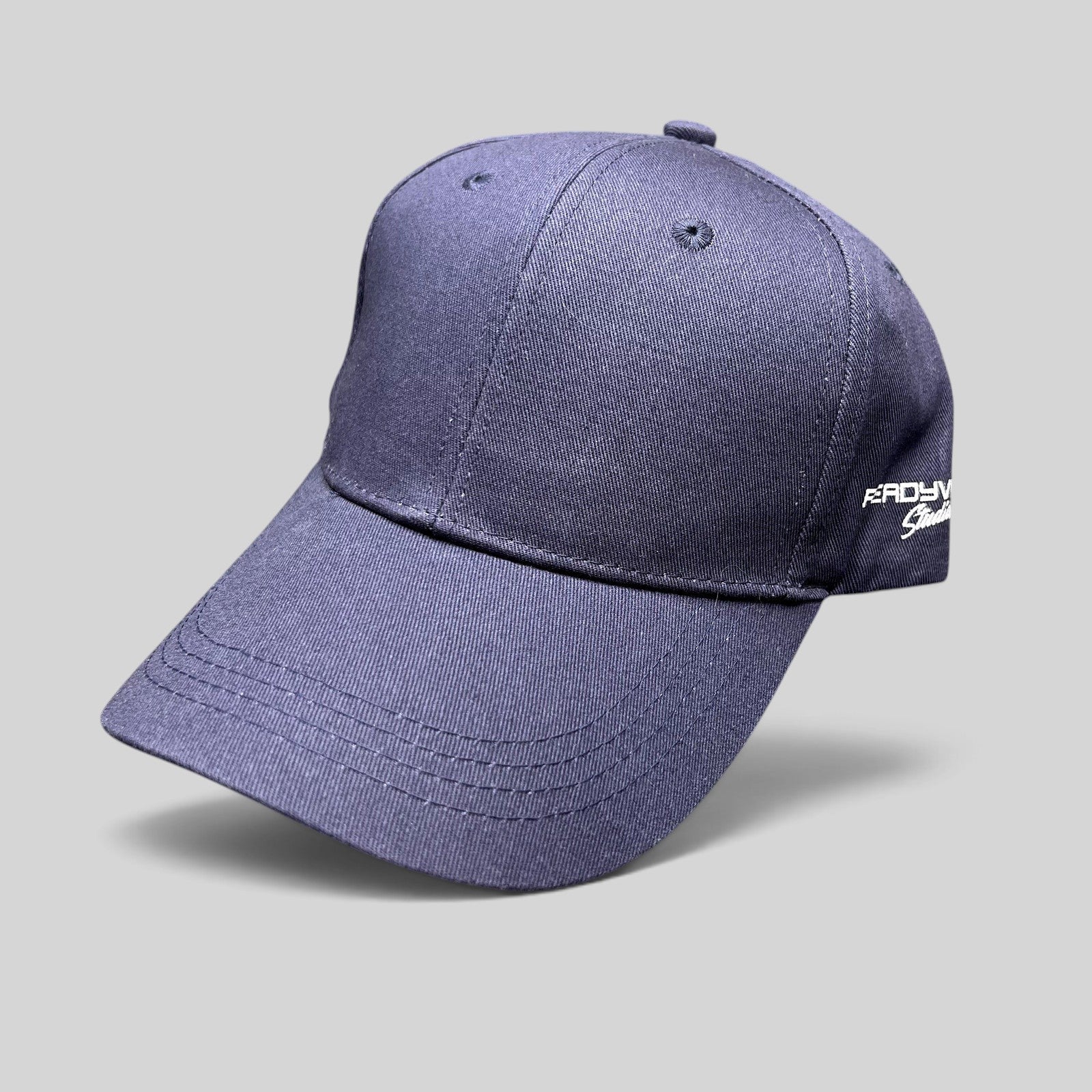 Raree Finds navy blue Readyverse Studios strapback dad cap with side embroidery and adjustable metal buckle closure.