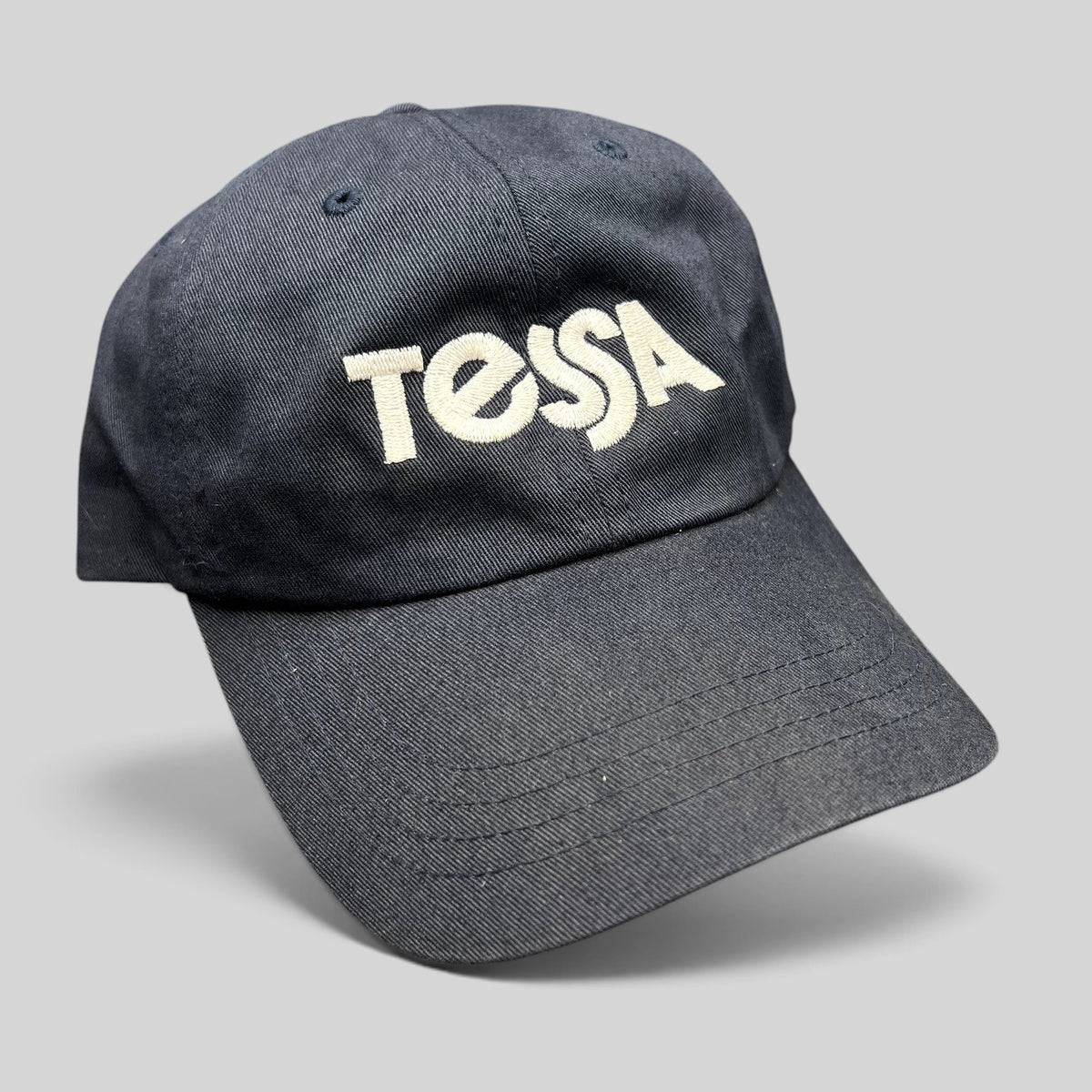 Raree Finds navy blue Yupoong Classics dad cap with white embroidered Tessa logo on the front