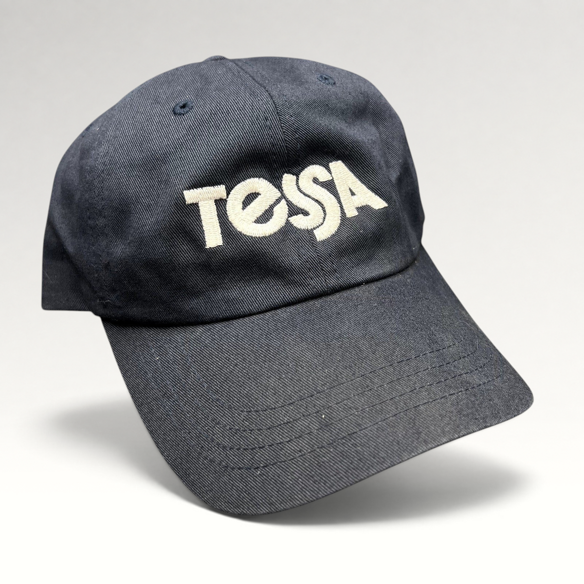 Raree Finds navy blue Yupoong Classics dad cap with white embroidered Tessa logo on the front
