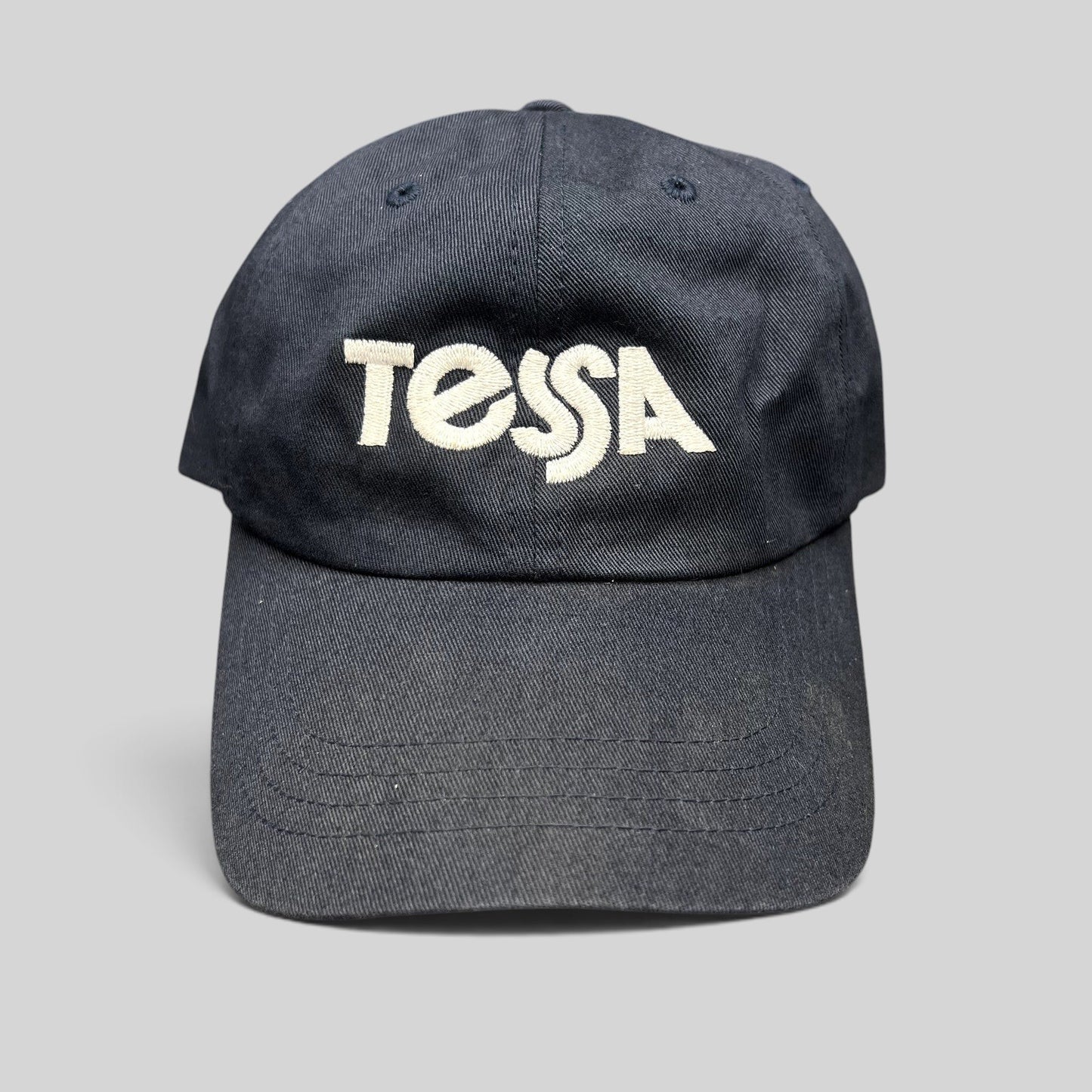 Raree Finds navy blue cotton dad cap with white embroidered Tessa logo and adjustable strapback closure