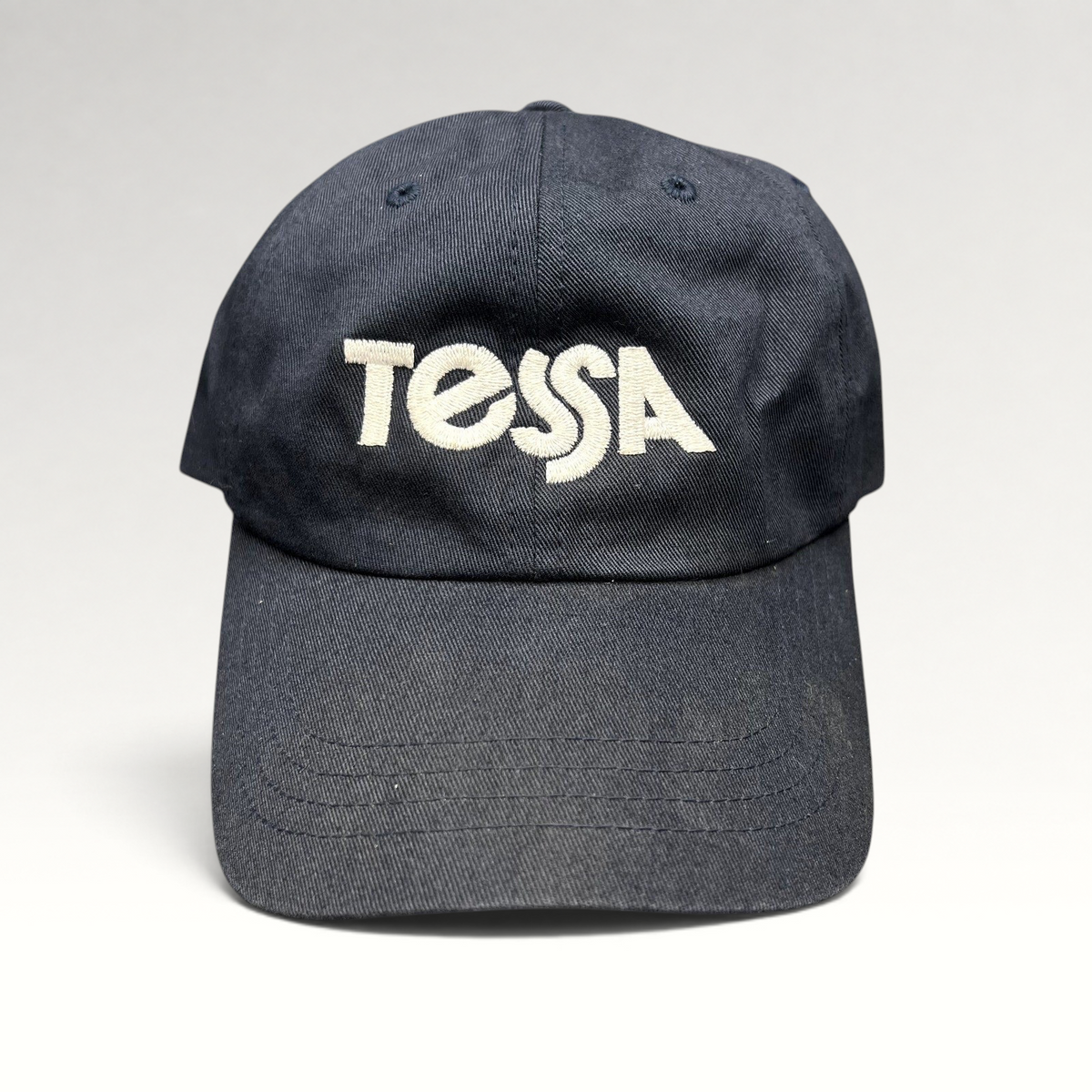Raree Finds navy blue cotton dad cap with white embroidered Tessa logo and adjustable strapback closure
