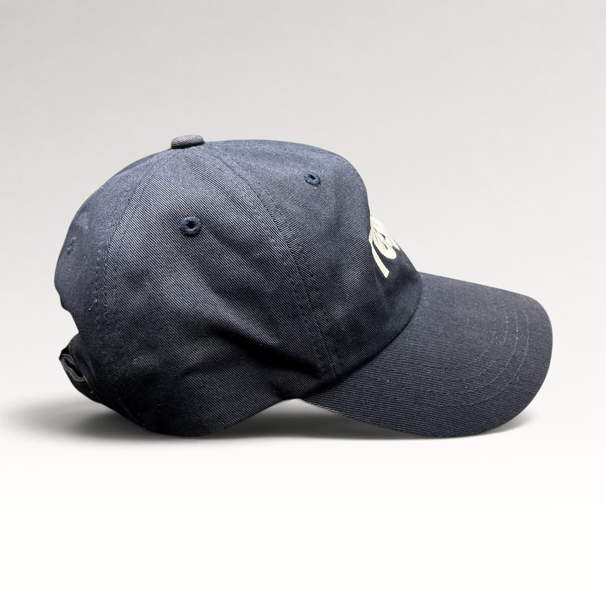 Raree Finds navy blue Tessa dad cap with white embroidered logo and adjustable brass buckle strapback closure