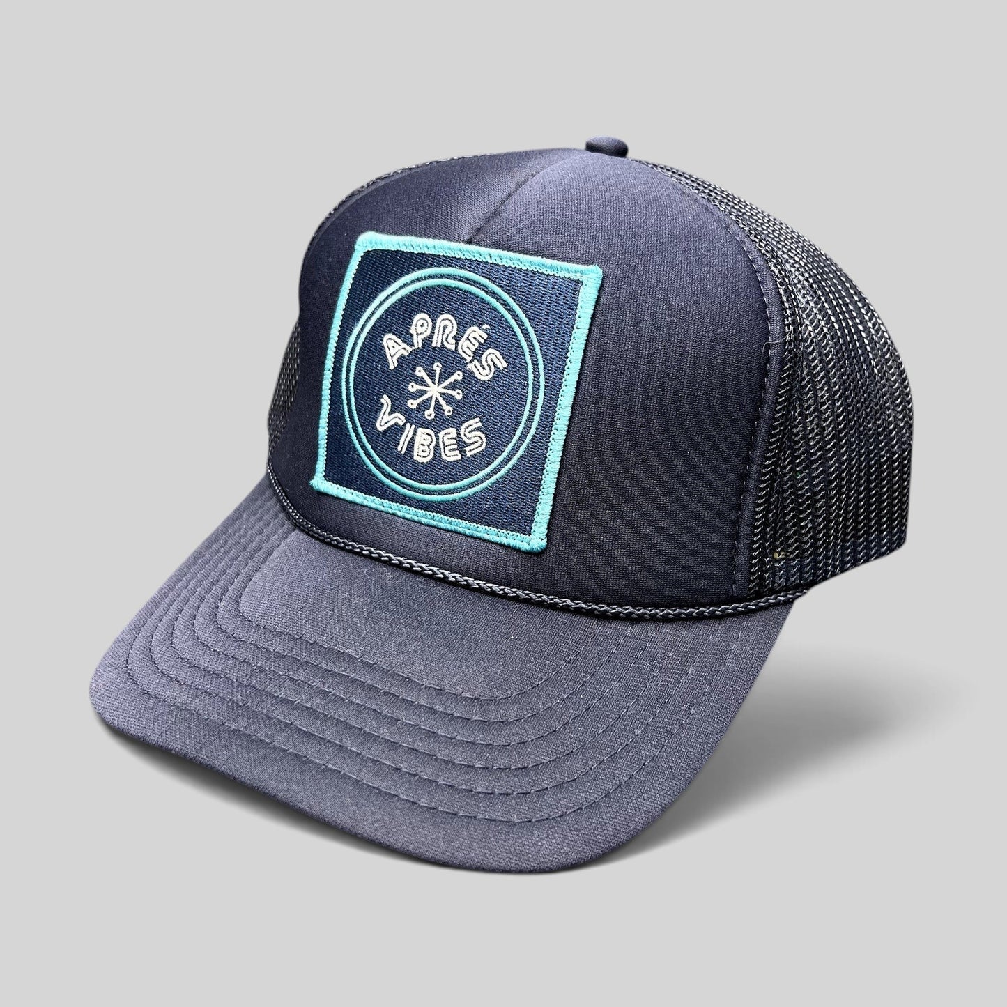 Raree Finds navy blue trucker hat with an Après Vibes embroidered patch and breathable mesh back