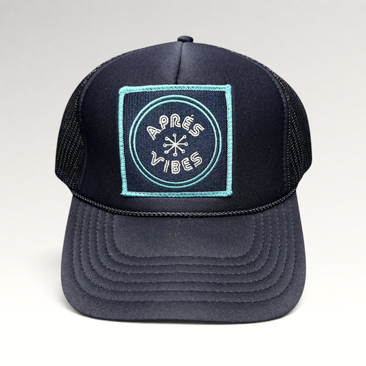Raree Finds navy blue trucker hat with an Après Vibes embroidered patch, mesh back, and adjustable snapback closure.