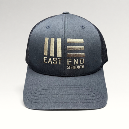 Raree Finds navy blue Yupoong Classics trucker hat with embroidered East End Studios logo and mesh back panels.