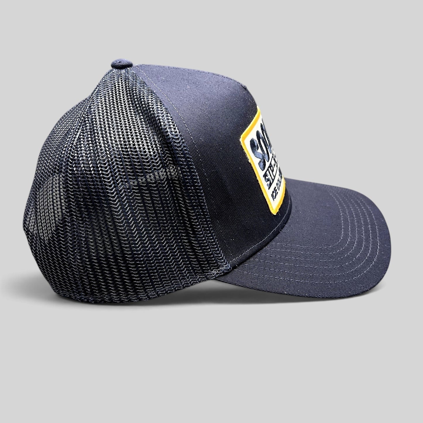 Raree Finds navy blue Otto trucker hat with a vintage Sip-N-Stop Ice Cold Natural Beer embroidered patch
