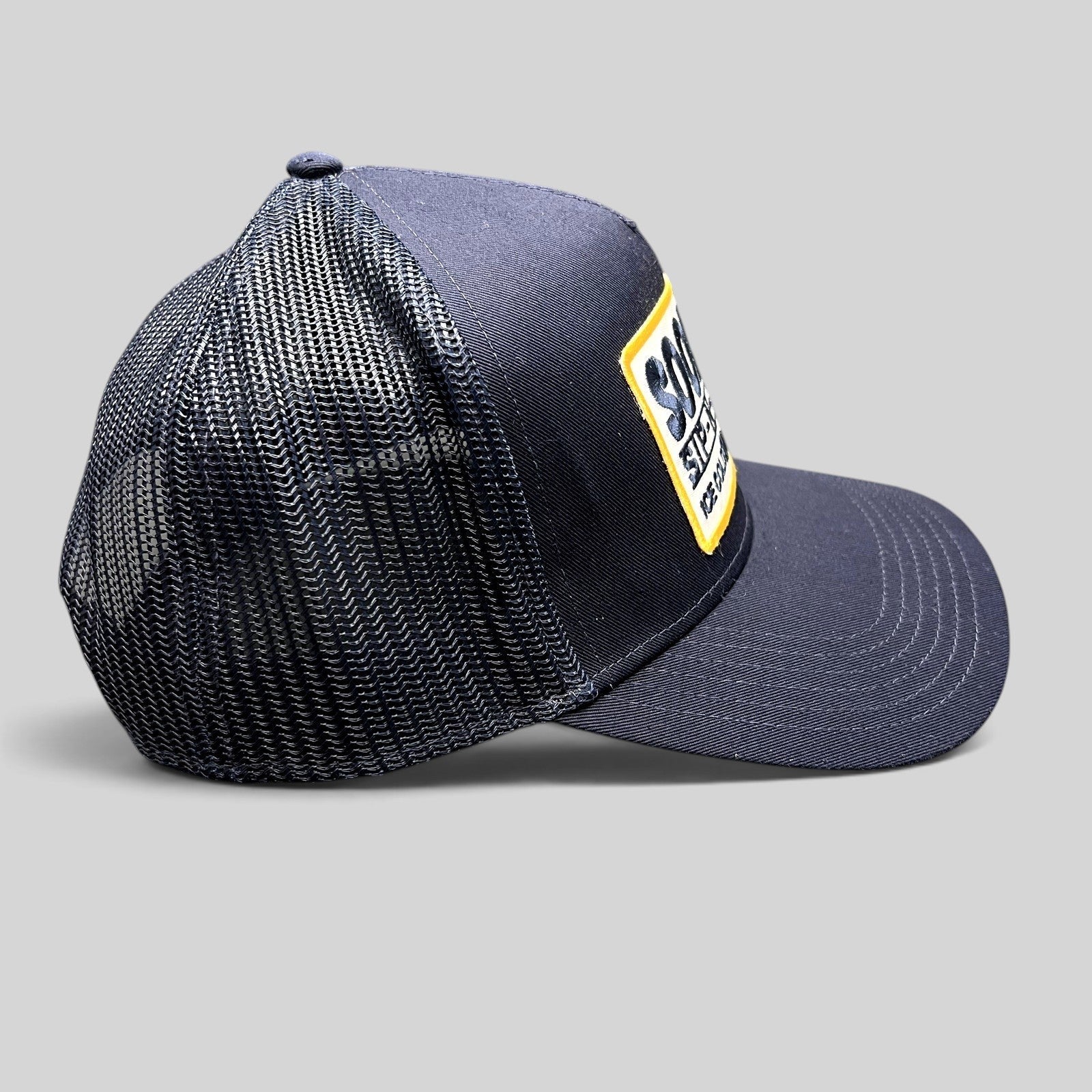 Raree Finds navy blue Otto trucker hat with a vintage Sip-N-Stop Ice Cold Natural Beer embroidered patch