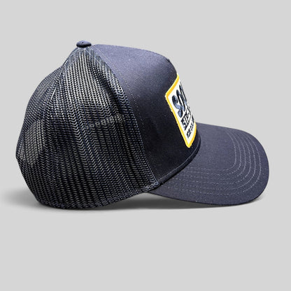 Raree Finds navy blue Otto trucker hat with a vintage Sip-N-Stop Ice Cold Natural Beer embroidered patch