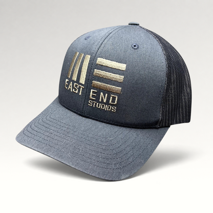 Raree Finds navy blue East End Studios trucker snapback hat with embroidered logo and breathable mesh back panels.