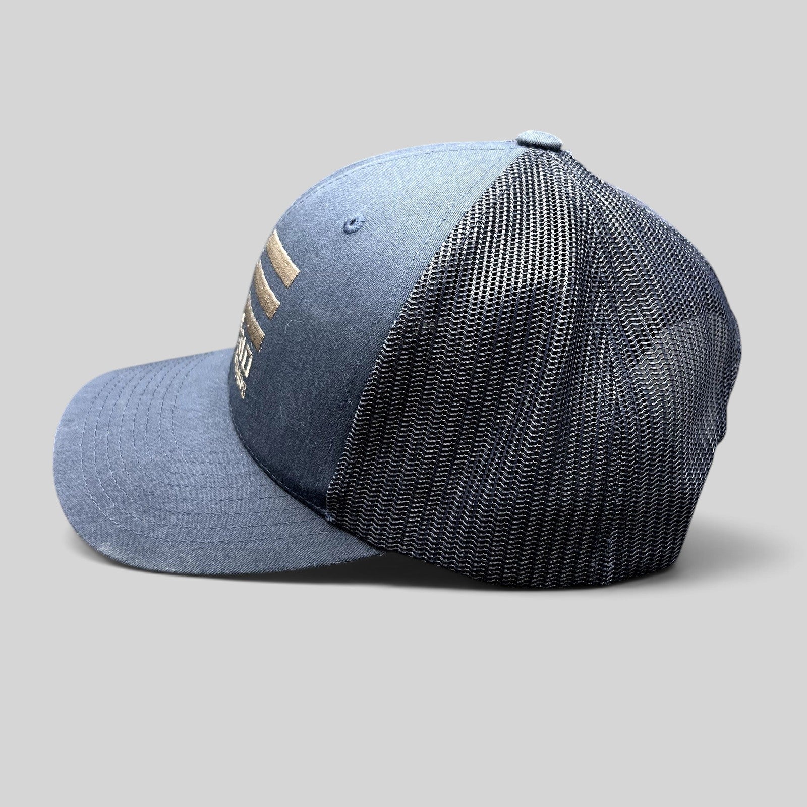 Raree Finds navy blue East End Studios trucker snapback hat with breathable mesh back and embroidered logo side view
