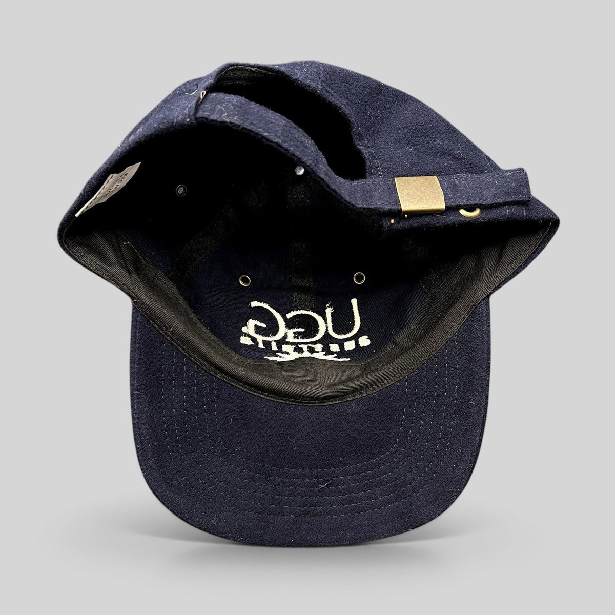 Raree Finds vintage navy blue cotton UGG Australia strapback hat with embroidered logo and brass buckle closure