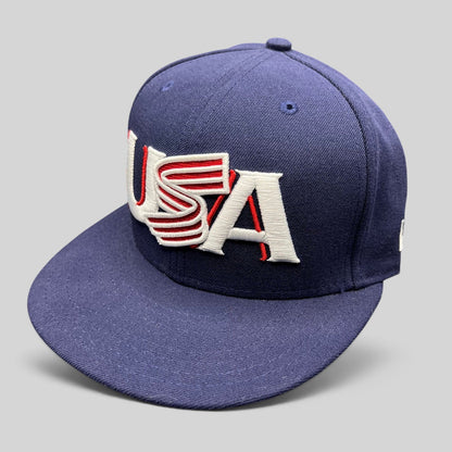 Raree Finds navy New Era 59FIFTY fitted hat with red and white USA Olympic embroidery and a structured flat brim.